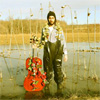 Gary Levitt standing in flood plain with cello